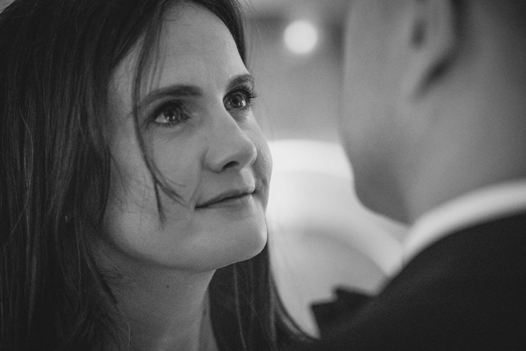 Intimate black and white close-up portrait of the bride gazing at the groom