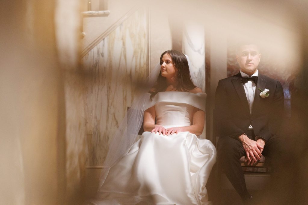 Bride and groom in a quiet moment together on a staircase, artistic double-exposure wedding portrait